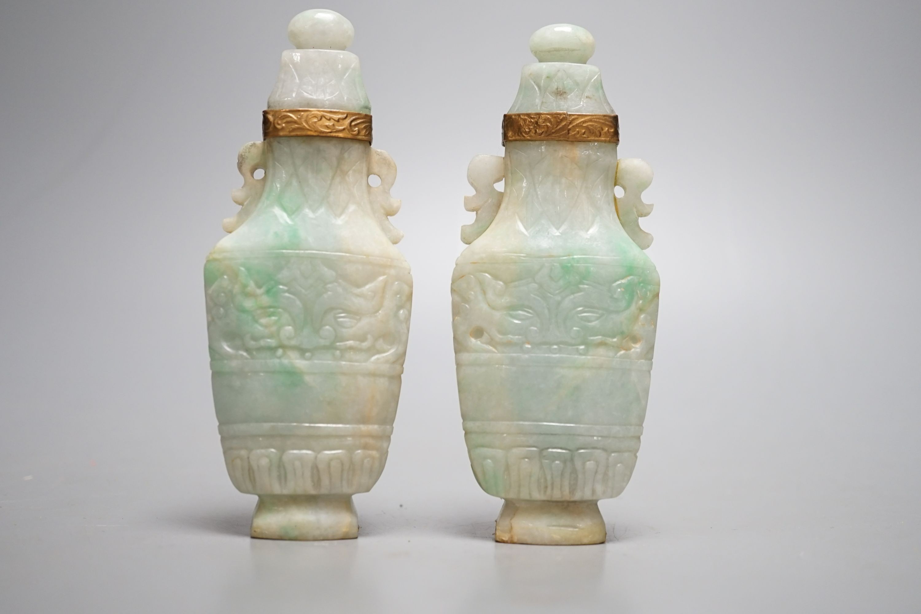 A pair of Chinese jadeite carved vases and covers